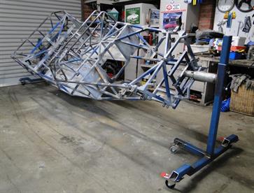 Chassis stripped of all removable components and mounted on a rotisserie for ease of access to all surfaces.  Ready to be taken back to bare metal in preparation for painting.