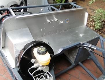 Scuttle and front firewall during final assembly with aluminium panels glued and riveted in place.